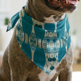 Symmetrical teal owl pattern with decorative floral elements on cream background