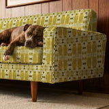 Stylized golden owls in symmetrical Art Nouveau pattern with floral motifs on cream background