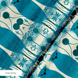 Symmetrical teal owl pattern with decorative floral elements on cream background