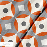 Mod Montez in Fire — mod montez print, in a cream star on a bright orange ground with a charcoal center