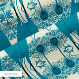 Symmetrical teal owl pattern with decorative floral elements on cream background