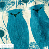 Symmetrical teal owl pattern with decorative floral elements on cream background